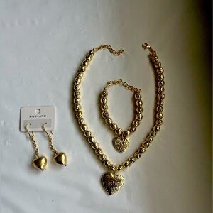 Gold tone earring ,necklace and bracelet set with heart shape pendant .
